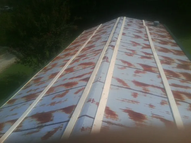 Rusted metal roof panels with new wood purlins before replacement — Storm Damage Roof Repair in Rio Grande by Roofing Brothers